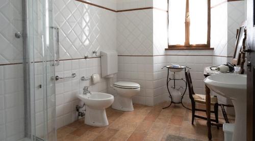 a bathroom with a toilet and a sink at B&B CorteBonomini entire home in Sasso