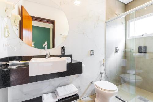 a bathroom with a sink and a toilet and a mirror at Ucayali Hotel in Sinop