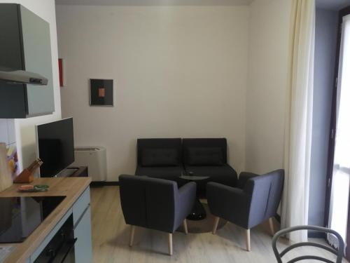 a living room with a couch and a table and chairs at SERRA E MESU Affittacamere in Magomadas