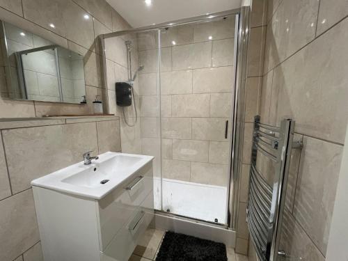 a bathroom with a shower and a sink and a shower at Cotes Yard in Loughborough