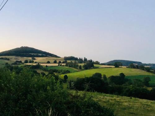 a green field with hills in the distance at Maison Belle Vue in Chiddes