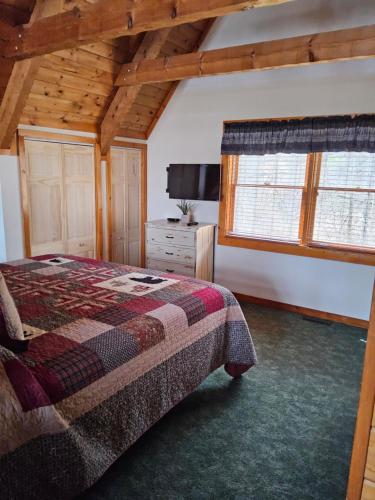 a bedroom with a bed and a wooden ceiling at Meadows Way 3378 in Pigeon Forge