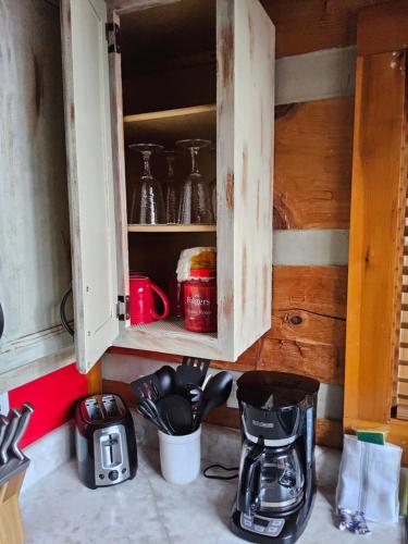 a kitchen cabinet with a coffee maker and a blender at Meadows Way 3378 in Pigeon Forge