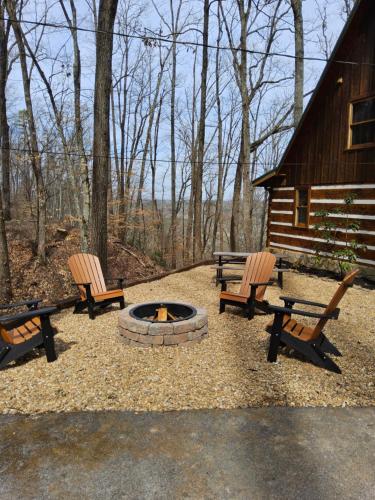 two benches and a fire pit in front of a cabin at Meadows Way 3378 in Pigeon Forge