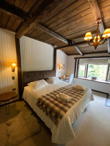 a bedroom with a large bed and a window at The Patagonian Lodge in Coihaique