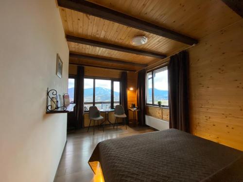 a bedroom with a bed and a table with chairs at AGORA Chalet in Slavske