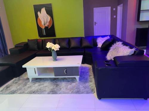 a living room with a couch and a coffee table at Joydora apartments 3 in Lusaka