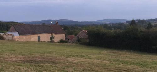 a house in the middle of a field at Maison Belle Vue in Chiddes