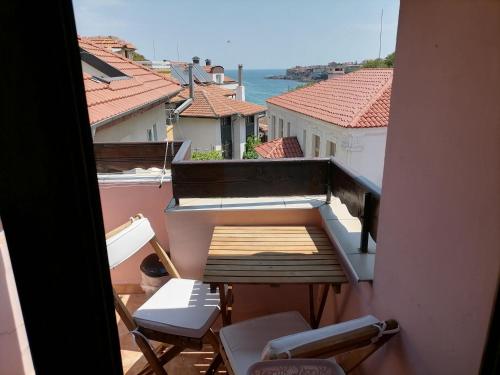 a balcony with chairs and a view of the water at Guesthouse Olimp in Sozopol