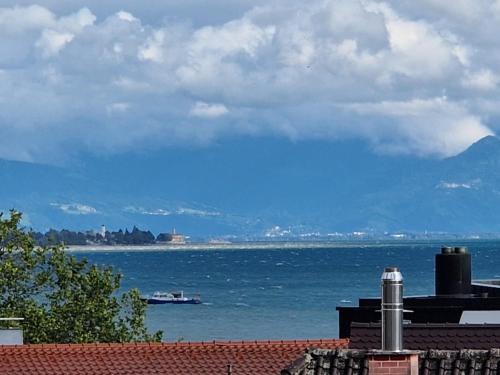 a view of the ocean with a boat in the water at Residence Seeblick in Friedrichshafen