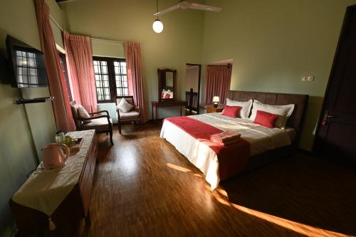 a bedroom with a large bed with red pillows at Serene Manor in Battaramulla