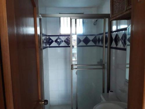 a glass shower in a bathroom with a toilet at El Peñón frente al mar in Gaira
