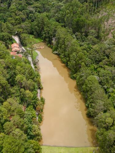 an aerial view of a river in a forest at Aventoriba Lodge in Campos do Jordão