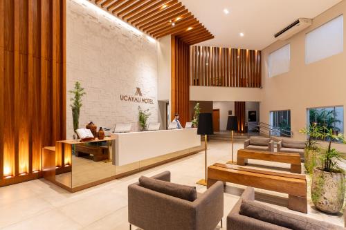 an office lobby with a reception desk and chairs at Ucayali Hotel in Sinop