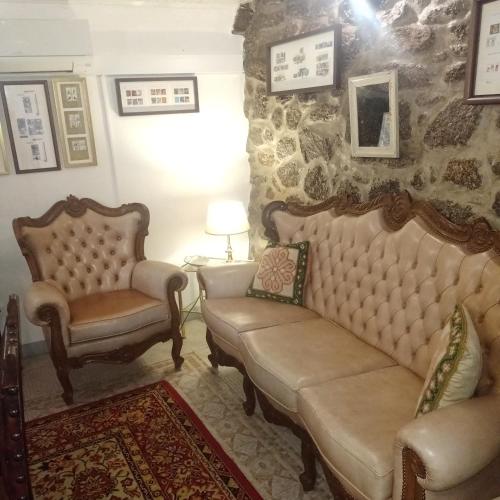a living room with two chairs and a couch at Casas do Durão-Memories House in Lajeosa