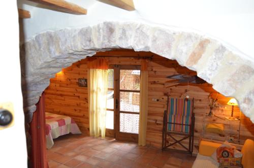 a room in a log cabin with a large doorway at La Casa Del Teix in Eslida