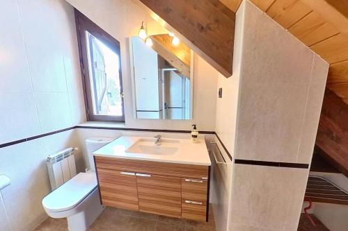 a bathroom with a sink and a toilet at Casa Ligües - tucasaenlospirineos in Escarrilla