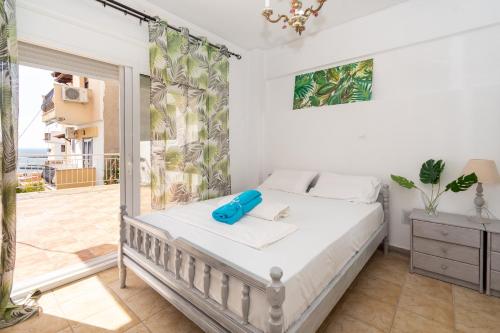 a bedroom with a bed and a balcony at Casa Del Mar in Neos Marmaras