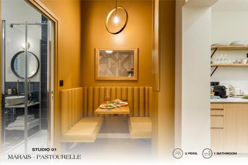 a bathroom with a table and a shower at Beauquartier - Marais, Pastourelle in Paris