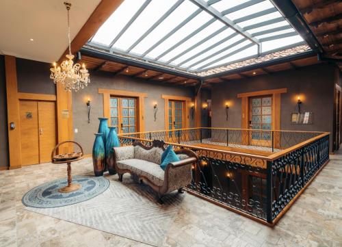a living room with a chandelier and a couch at Hotel Cruz del Vado by Art Hotels in Cuenca