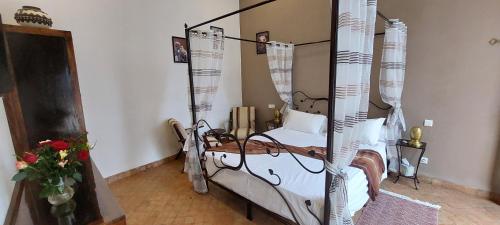 a room with a bed and a chair in it at Riad Ramzi in Marrakech