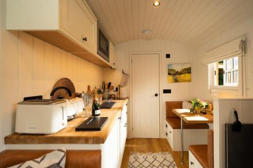 a kitchen with a sink and a counter top at Shepherd's Rest Luxurious Hideaway in Glasgow