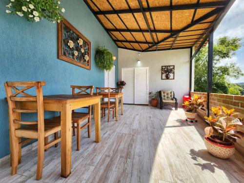 a dining room with a wooden table and chairs at Pousada Geada de Campos in Campos do Jordão