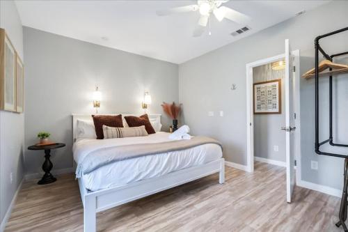 a white bedroom with a bed and a ceiling fan at Luxe Farmhouse ~ Hot Tub + Pool ~ Great4Gatherings in Manor