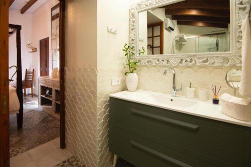 a bathroom with a sink and a mirror at Camp de sa mar in Port de Soller