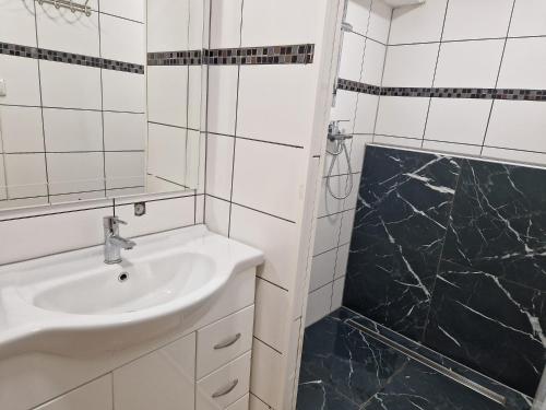 a white bathroom with a sink and a shower at Appartment in Oberndorf bei Schwanenstadt in Schwanenstadt