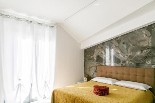 a bedroom with a large bed with a yellow blanket at RESIDENCE MARCO POLO in Montesilvano