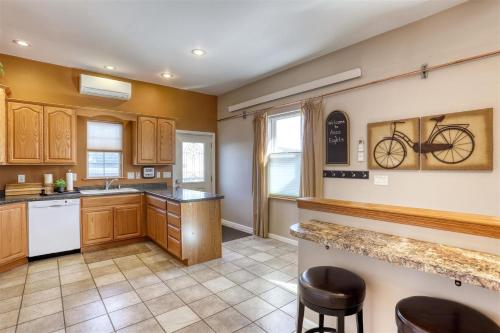 a kitchen with wooden cabinets and a bike on the wall at Aces & Eights in Sturgis