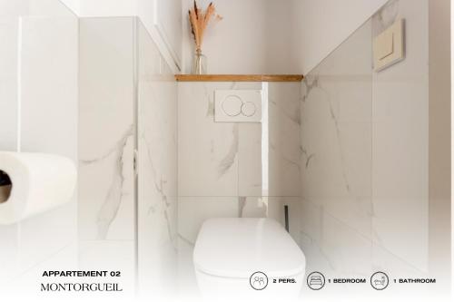 a white bathroom with a toilet and a shower at Beauquartier - Montorgueil in Paris