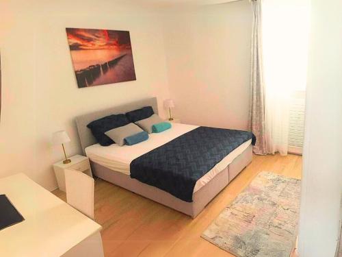 a bedroom with a bed and a desk in a room at Holiday Apartment Nina,Zadar in Zadar