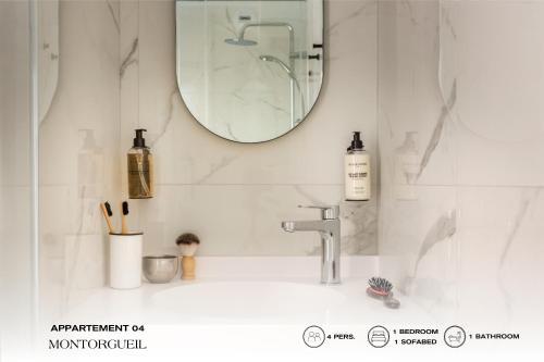 a bathroom with a sink and a mirror at Beauquartier - Montorgueil in Paris