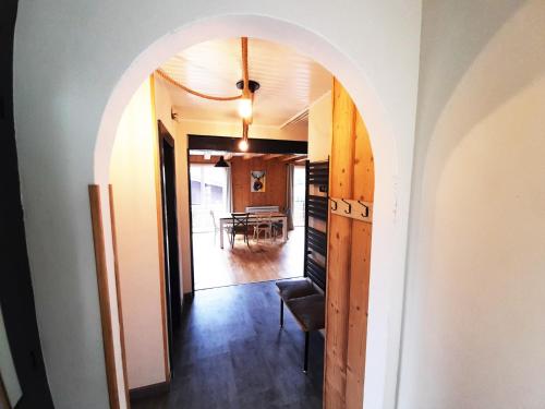 an archway leading into a dining room with a table at Chalet de Xonrupt / Vue splendide sur les montagnes in Xonrupt-Longemer