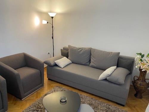 a living room with a couch and a chair at Miles Relax Station 2 in Chełm