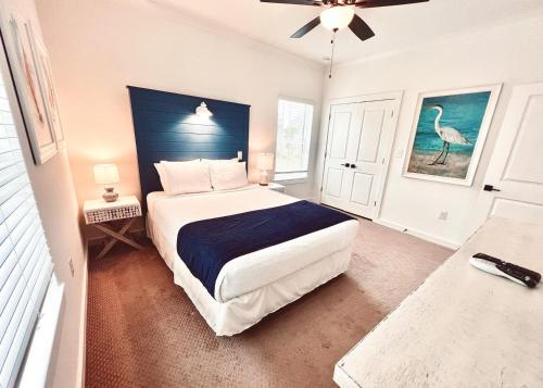 a bedroom with a large bed with a blue headboard at Beautiful 3br/25ba w/ Kayak access, Sleeps 10 in Orange Beach