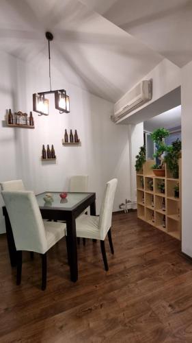 une salle à manger avec une table et des chaises blanches dans l'établissement skopje centar apartment, à Skopje
