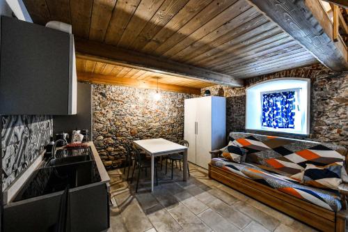 a kitchen with a bed and a table in a room at RUSTICO ALLE MURA Love & Bike in Toirano