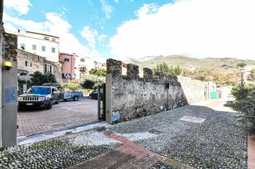 an open door to a street with a wall at RUSTICO ALLE MURA Love & Bike in Toirano