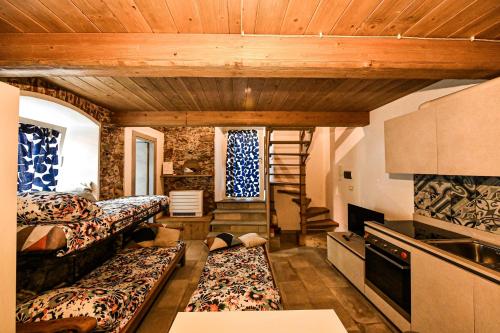 a small room with two beds and a staircase at RUSTICO ALLE MURA Love & Bike in Toirano