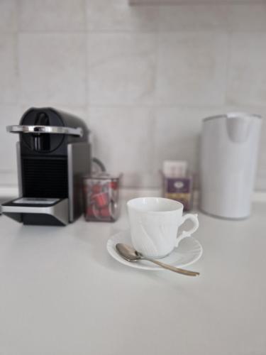 a coffee cup sitting on a counter next to a coffee maker at Ancora qui, nel Golfo dei Poeti in La Spezia