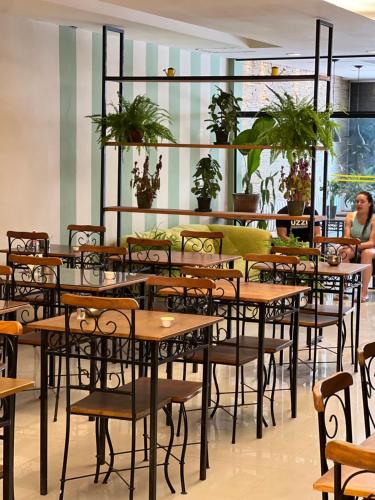 a group of tables and chairs in a restaurant at HMG - Praia de Botafogo in Rio de Janeiro