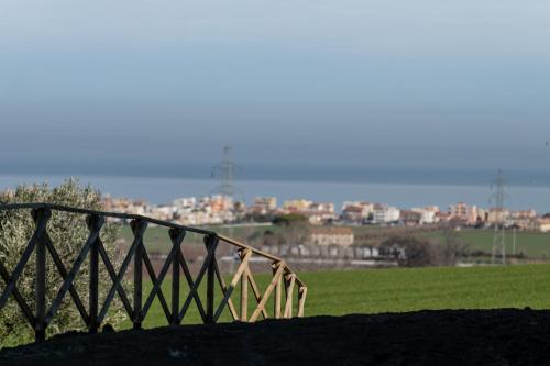a bridge in a field with a city in the background at Casa Addis B&B in Scapezzano