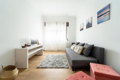 a living room with a couch and a table at Casino and Beach Apartment by House and People in Póvoa de Varzim