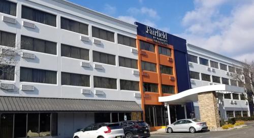 an office building with cars parked in front of it at Fairfield Inn & Suites Parsippany in Parsippany