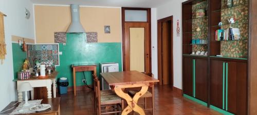 a kitchen with a wooden table in a room at Stasion Di Pueste in Nogaredo Al Torre