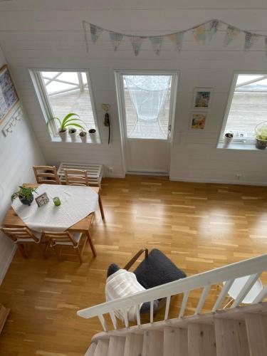a living room with a staircase and a table at Lövlingskulle in Sandöverken