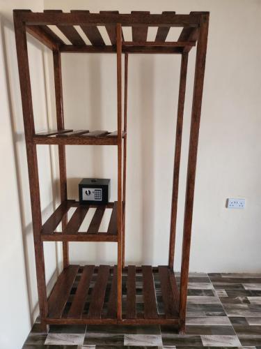 a wooden shelf with a radio in a room at Two Palms in Jambiani